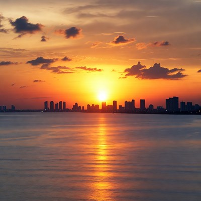 Sunset over city skyline and water