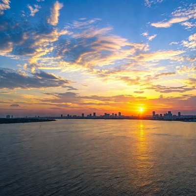 Sunset over city skyline and river