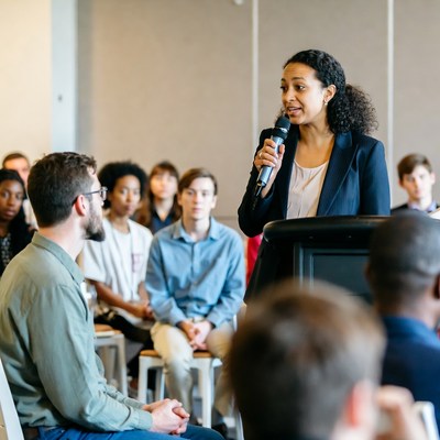 African-American woman speaking at podium