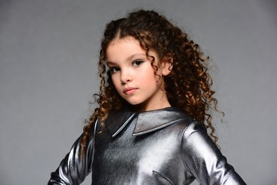 Girl with curly hair in silver dress