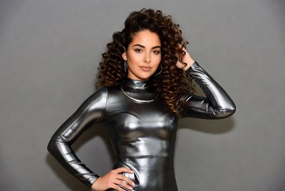 Woman in shiny silver turtleneck dress