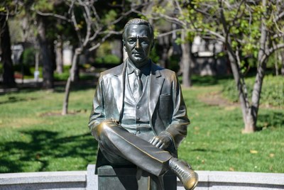Bronze Statue of Seated Man in Suit