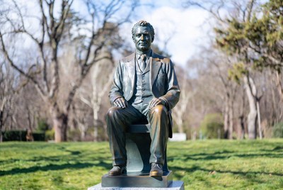Bronze Statue of Seated Man in Suit