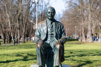 Bronze Statue of Seated Man in Park