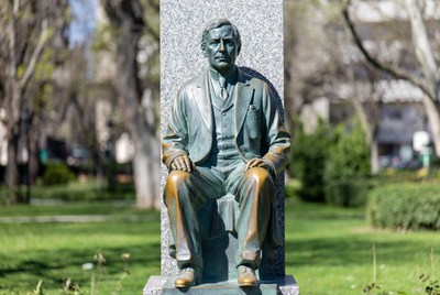 Bronze Statue of Seated Man in Park