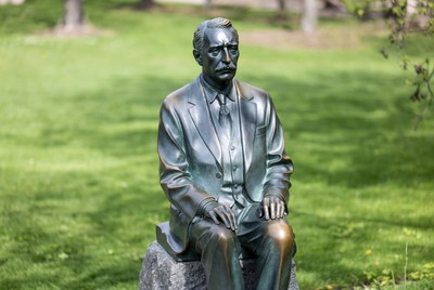 Bronze Statue of Seated Man in Park