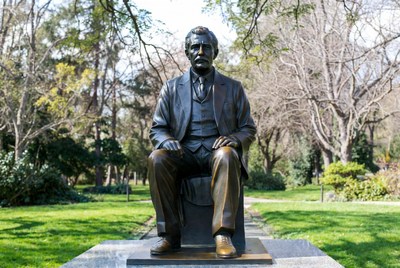 Bronze Statue of Seated Man in Park