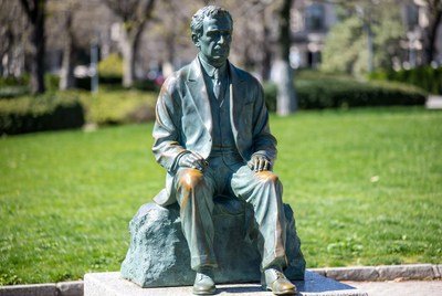 Bronze Statue of Seated Man in Park
