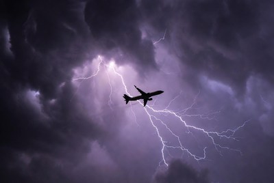 Airplane flying through thunderstorm lightning