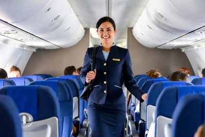 Smiling Asian flight attendant in airplane