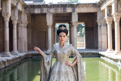 Indian woman in silver gown at ancient temple