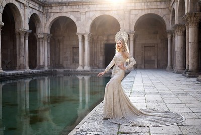 Blonde woman in gold gown by pool