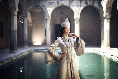 Woman in white traditional dress by pool