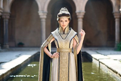 Woman in ornate gown at courtyard