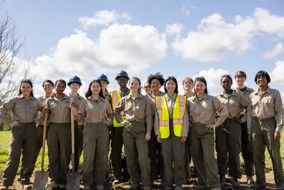Diverse conservation team with shovels outdoors