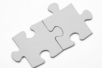 Two interlocking gray puzzle pieces