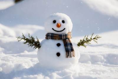 Snowman with scarf in snow