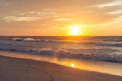 Sunset beach with footprints