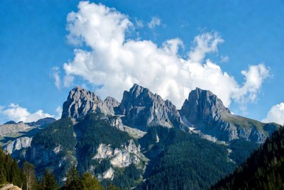 Majestic Rocky Peaks with Forests and Clouds