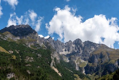 Majestic Mountains with Clouds and Green Slopes