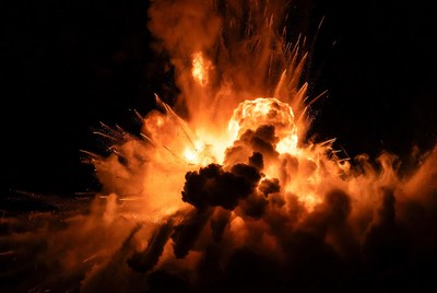 Massive fiery explosion in dark sky