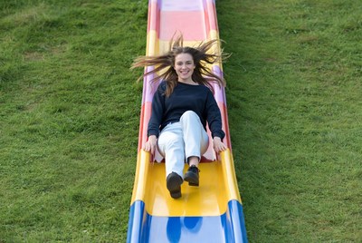 Girl sliding down colorful slide
