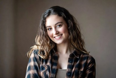 Smiling woman in plaid shirt