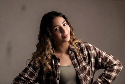 Smiling Latina woman in plaid shirt