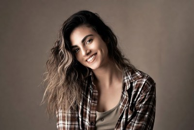 Smiling woman with wavy brown hair