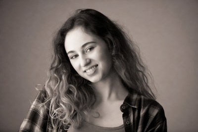 Smiling young woman with curly hair