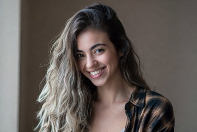 Smiling woman with wavy brown hair