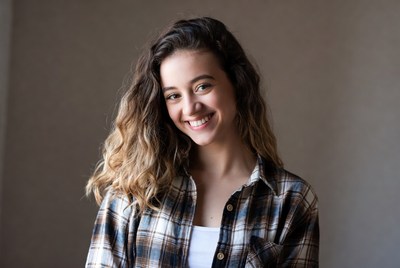 Smiling young woman in plaid shirt