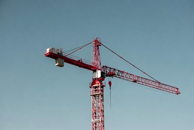 Red Tower Crane Against Blue Sky