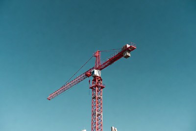 Red Construction Crane Against Blue Sky