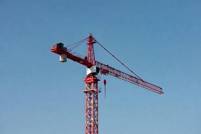 Red Tower Crane Against Blue Sky