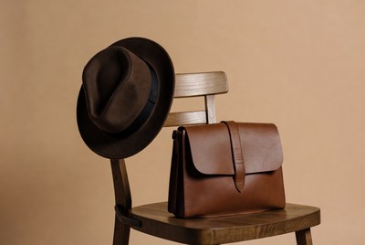 Brown Fedora Hat and Leather Bag on Chair