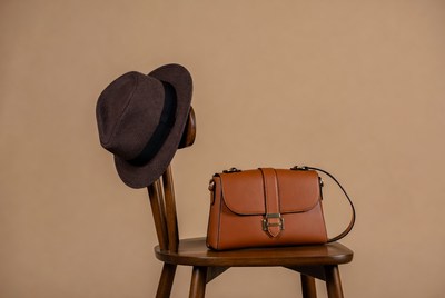 Brown Hat and Leather Handbag on Chair
