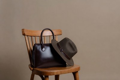 Brown leather handbag with fedora hat