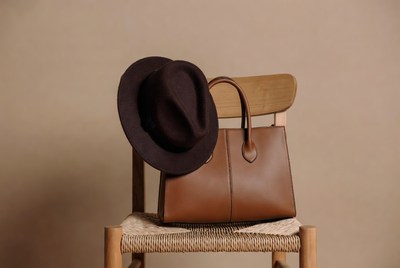 Brown Fedora Hat and Leather Handbag on Chair