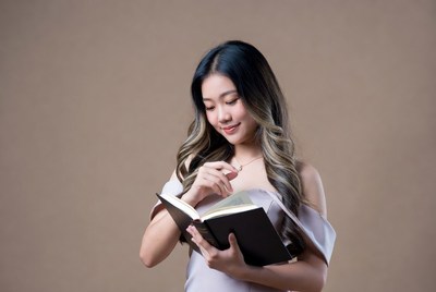 Asian woman reading book