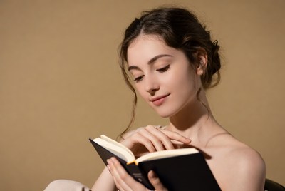 Nude woman reading book