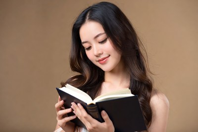 Asian woman reading book