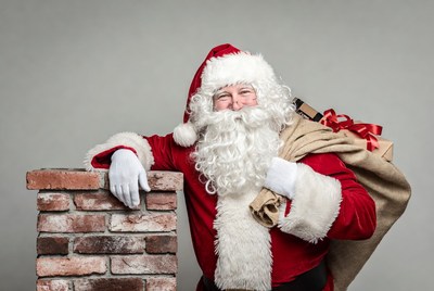 Santa Claus leaning on brick chimney