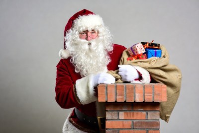 Santa Claus with sack on chimney