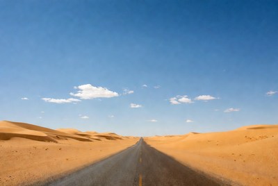 Desert road through sand dunes