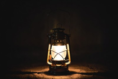 Vintage Lantern Glowing on Dark Ground