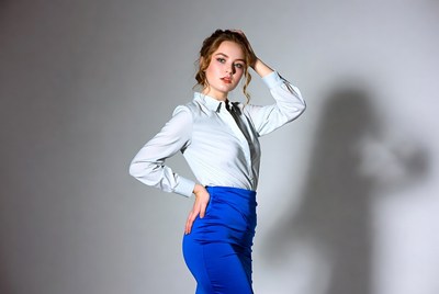 Woman posing in white blouse blue skirt