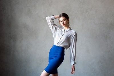 Woman posing in white blouse blue skirt