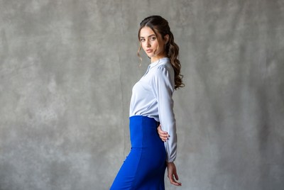 Woman in white blouse blue skirt