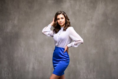 Woman in white blouse blue skirt